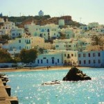 Mykonos-Greece-hillside-white-blue-houses-rock-in-water